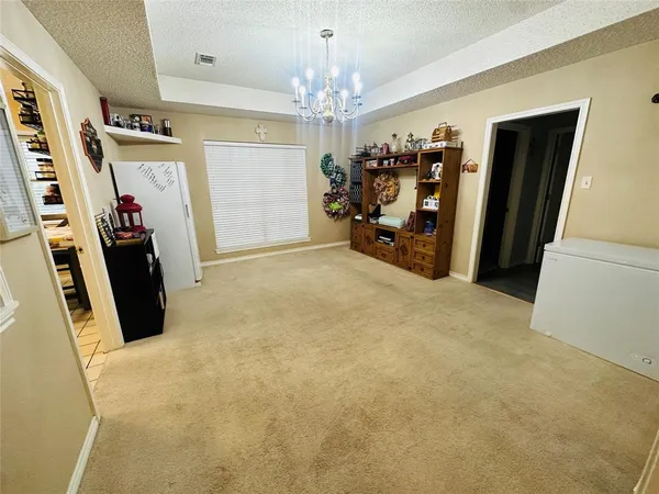 a view of a dining room with furniture and chandelier