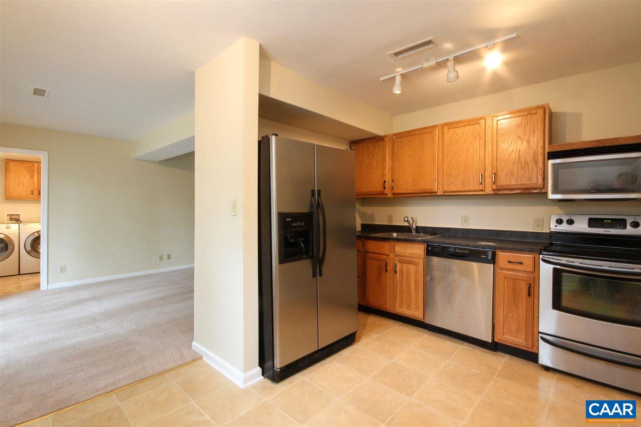 1254 Villa Lane, Unit A Charlottesville, VA 22903 - Photo 4 of 10 a kitchen with stainless steel appliances granite countertop a refrigerator and a stove top oven
