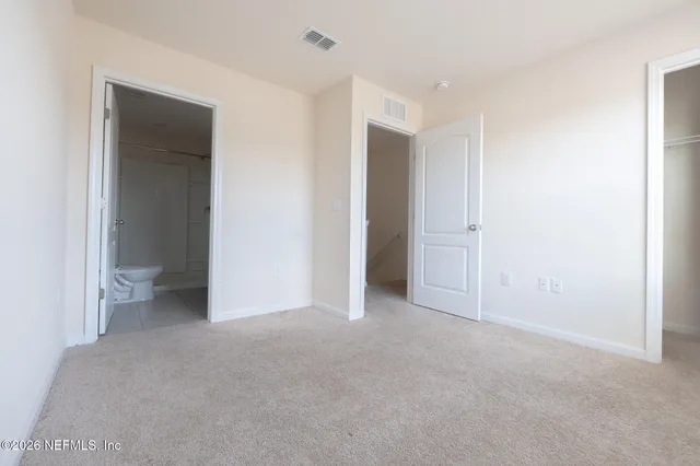an empty room with closet area