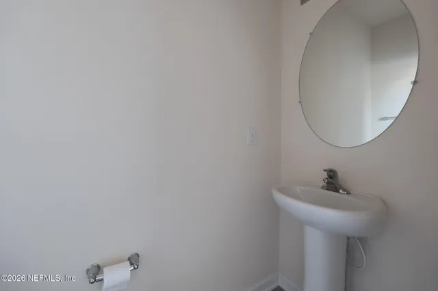 a bathroom with a sink and mirror