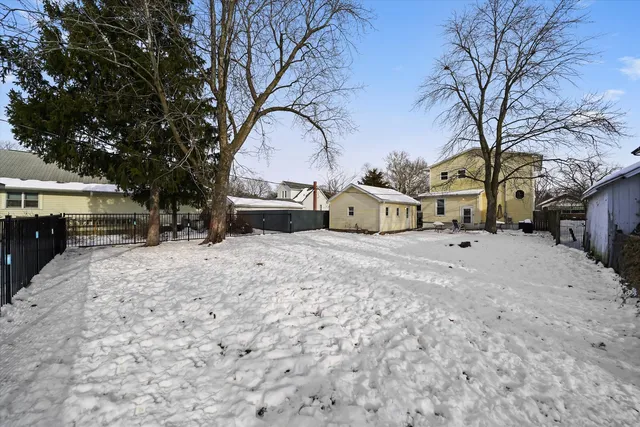 a view of a house with a snow in the yard