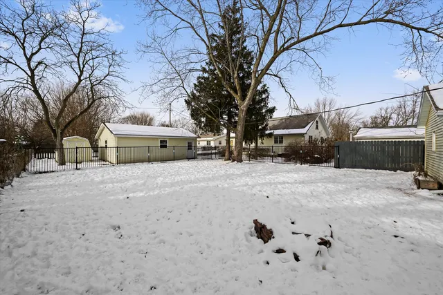 an aerial view of a residential houses with yard