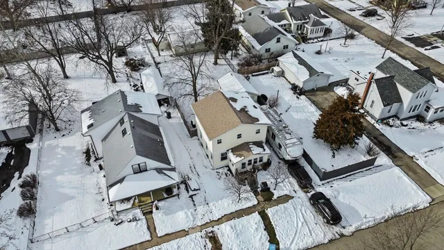 an aerial view of a house with a yard