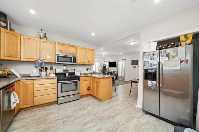 a kitchen with granite countertop stainless steel appliances and white cabinets