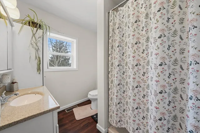 a bathroom with a sink a vanity and a toilet