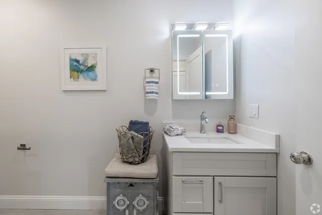 a bathroom with a sink vanity and a mirror