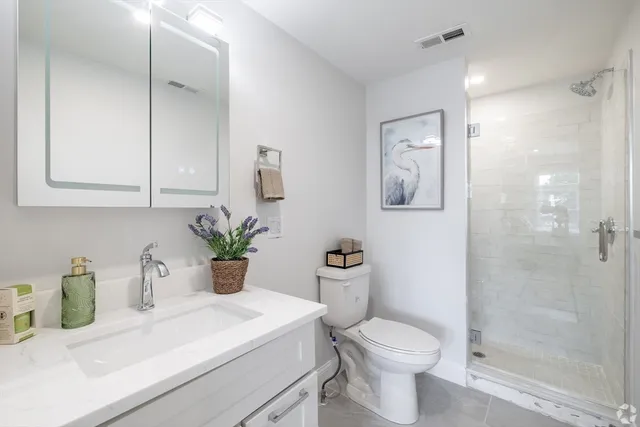 a bathroom with a sink toilet and shower