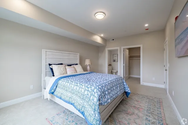 a bedroom with a bed and a lamp