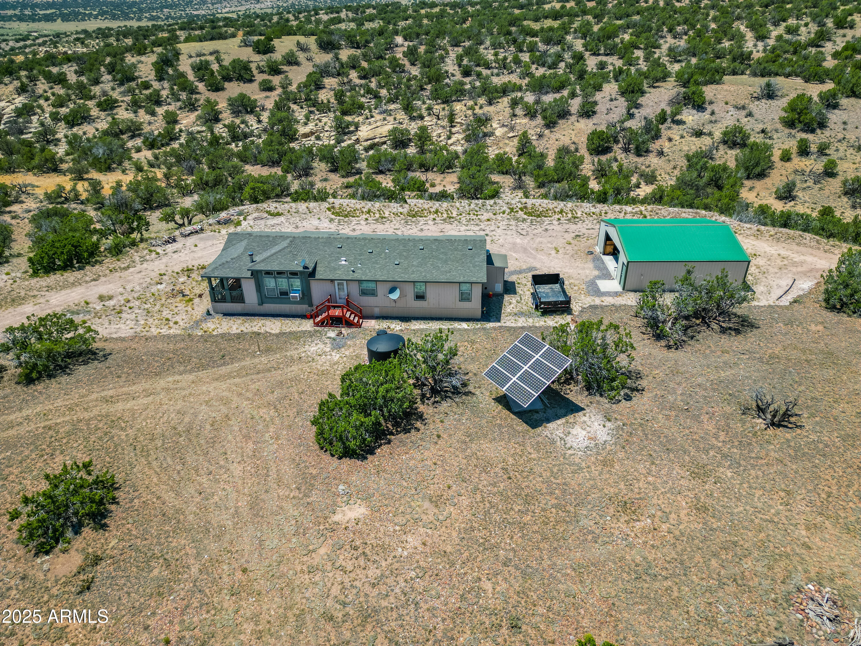 an aerial view of a house with garden space and street view