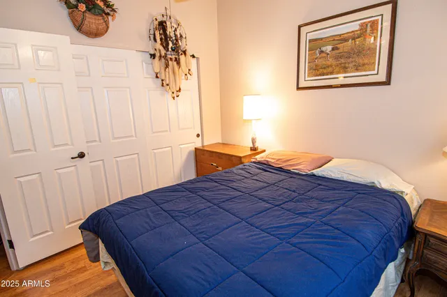 a bedroom with a bed and a painting on the wall