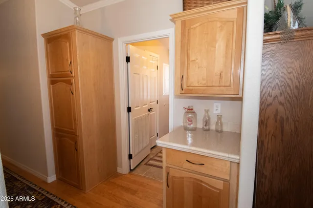 a kitchen with a refrigerator and cabinets