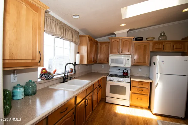 a kitchen with stainless steel appliances a sink a stove and a refrigerator