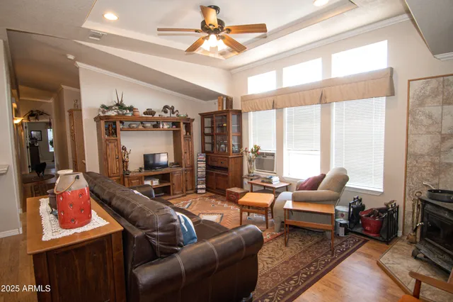 a living room with furniture a flat screen tv and a large window