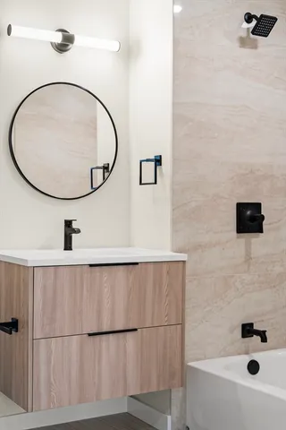 a bathroom with a sink a toilet and a mirror