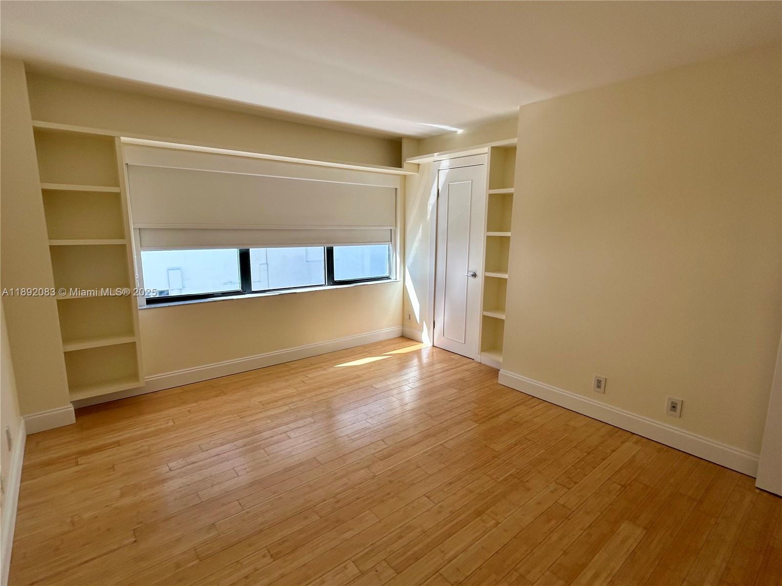 5415 Collins Avenue, Unit 302 Miami Beach, FL 33140 - Photo 15 of 33 a view of an empty room with wooden floor and a window