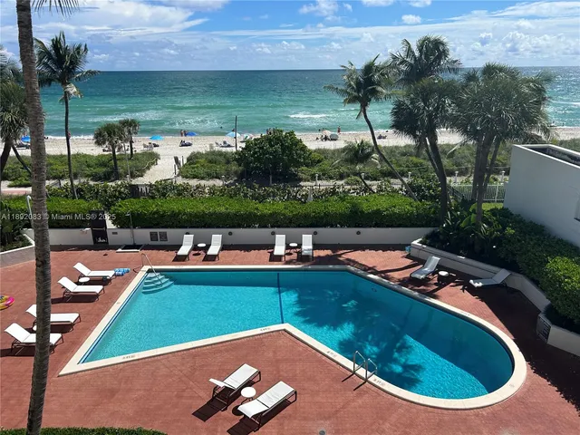a view of a swimming pool with a yard