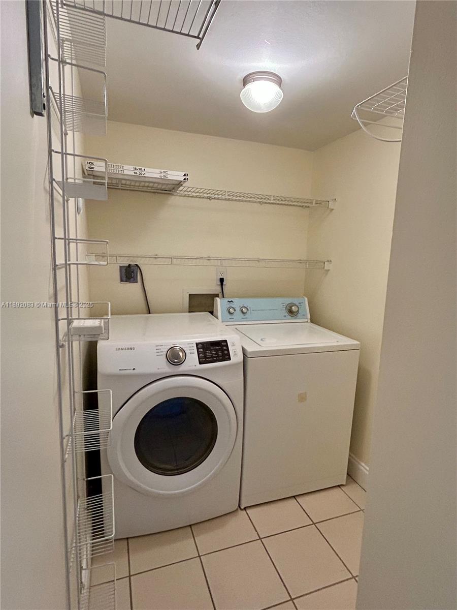 5415 Collins Avenue, Unit 302 Miami Beach, FL 33140 - Photo 22 of 33 a utility room with dryer and washer
