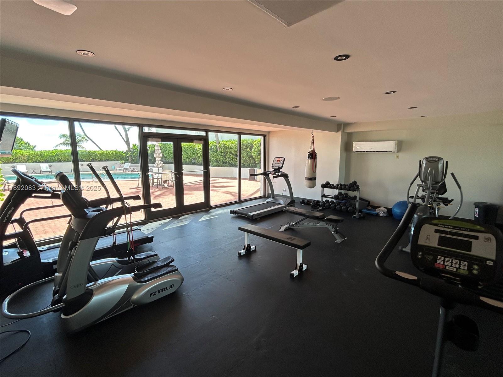 5415 Collins Avenue, Unit 302 Miami Beach, FL 33140 - Photo 30 of 33 a room with gym equipment and floor to ceiling window