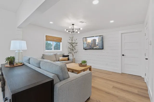 a view of a dining room with furniture and chandelier
