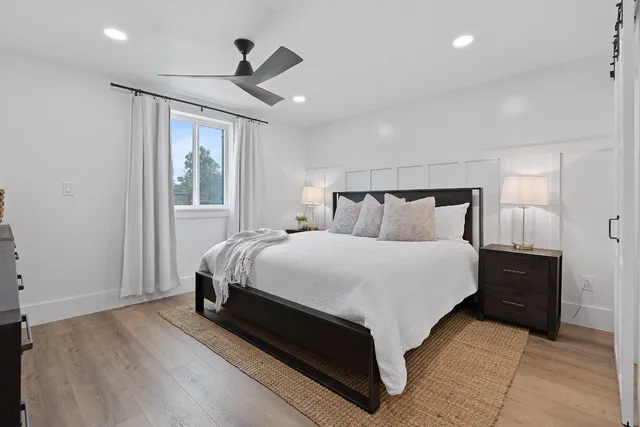 a bedroom with a bed and a chair