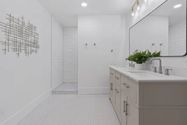 a bathroom with a toilet a sink a mirror and vanity