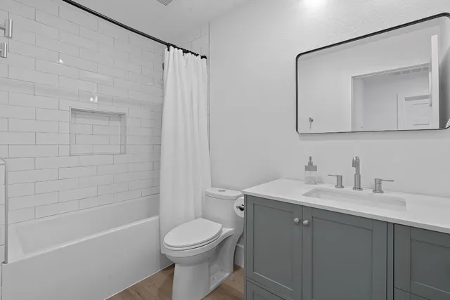 a bedroom with a bed and a dresser