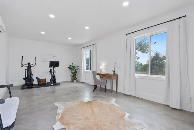 a white house that has a tree in front of it