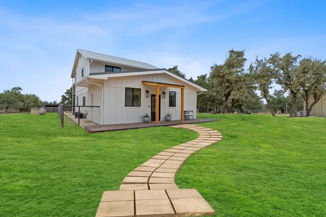 a front view of house with a garden