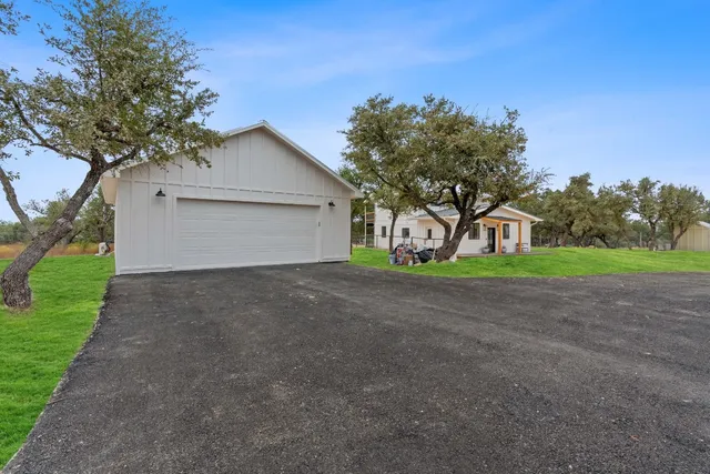 a view of a house with a yard and garage