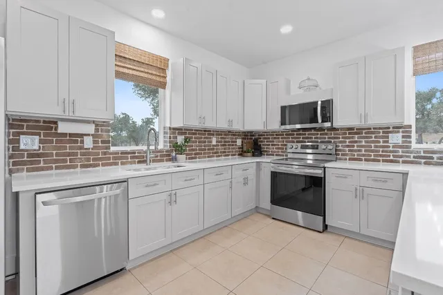 a living room with furniture and a view of kitchen