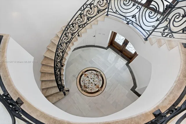 a kitchen with granite countertop a stove a sink and a refrigerator