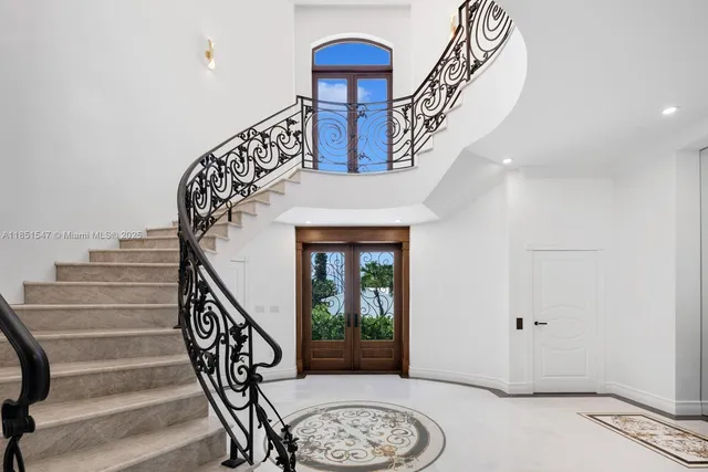 a kitchen with stainless steel appliances granite countertop a sink a stove and a wooden floors
