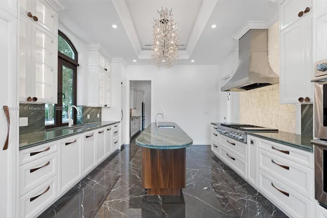 a bathroom with a granite countertop sink a large mirror and a shower
