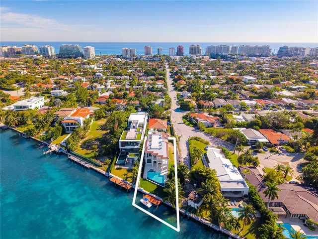 an aerial view of residential houses with outdoor space and parking