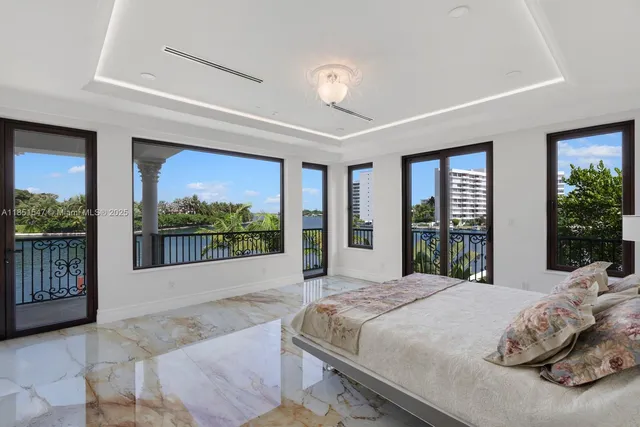 a spacious bedroom with a large bed and a large window