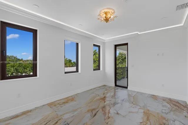 a bedroom with a bed table and a large window