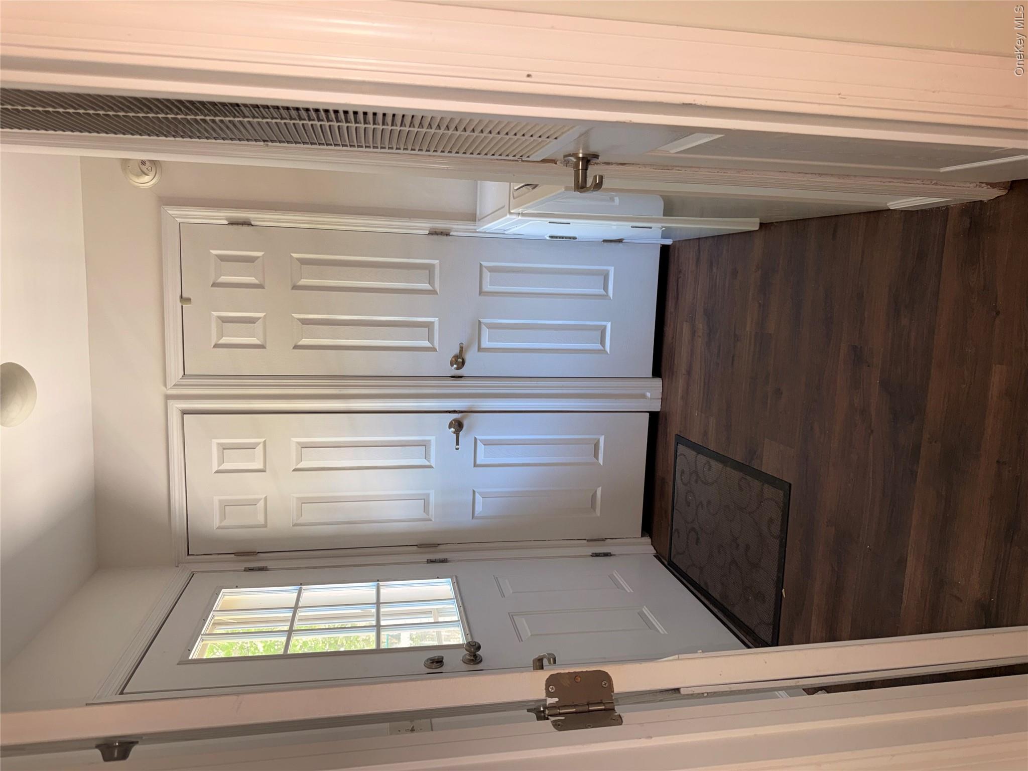 1661 Old Country Road, Unit 516 Riverhead, NY 11901 - Photo 21 of 50 a view of a hallway with wooden floor and staircase