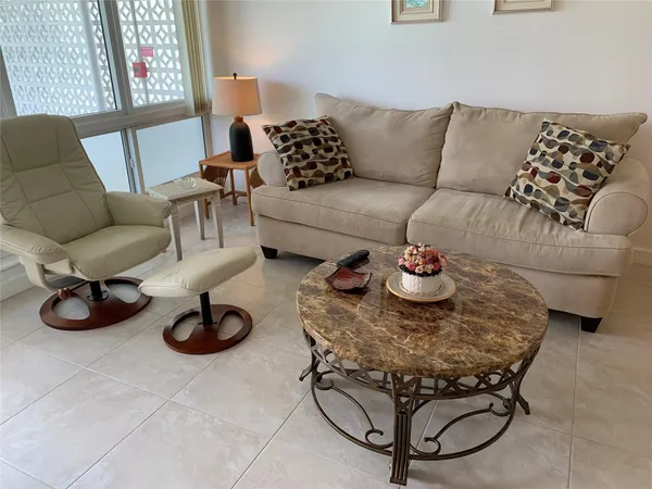 a living room with furniture and a rug