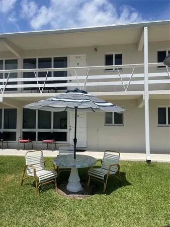 a view of a patio with table and chairs and potted plants