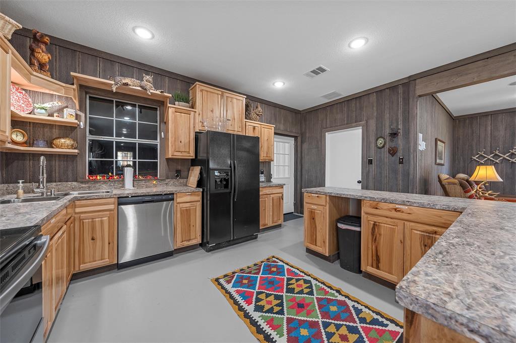 1170 Lumkins Road Forreston, TX 76041 - Photo 28 of 40 a kitchen with stainless steel appliances granite countertop a sink stove and refrigerator