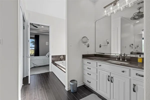 a spacious bathroom with a double vanity sink a mirror and shower