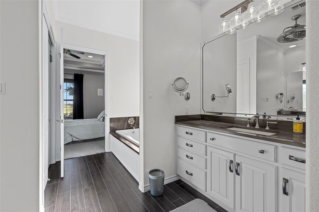 1170 Lumkins Road Forreston, TX 76041 - Photo 9 of 40 a spacious bathroom with a double vanity sink a mirror and shower