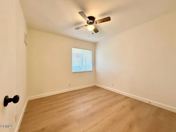 a view of a room with a ceiling fan