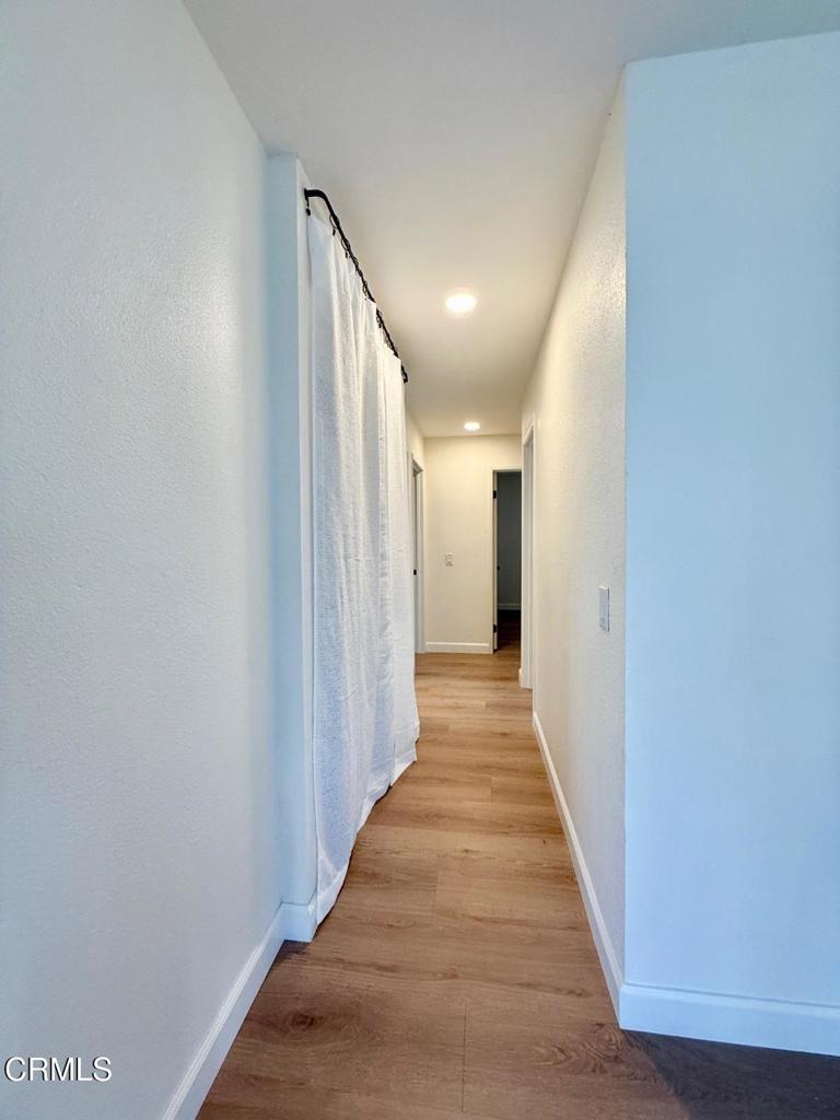225 South Ventura Road, Unit 79 Port Hueneme, CA 93041 - Photo 15 of 28 a view of a hallway with wooden floor