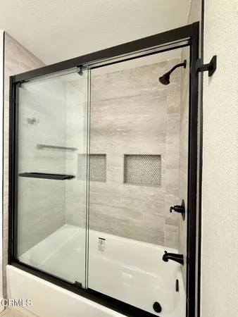 a bathroom with a glass shower door