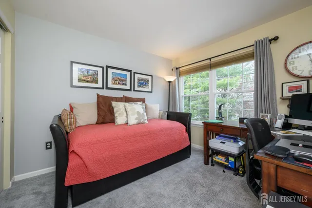a bedroom with furniture and a flat screen tv