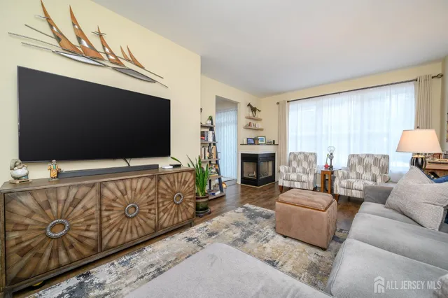 a living room with furniture and a book shelf