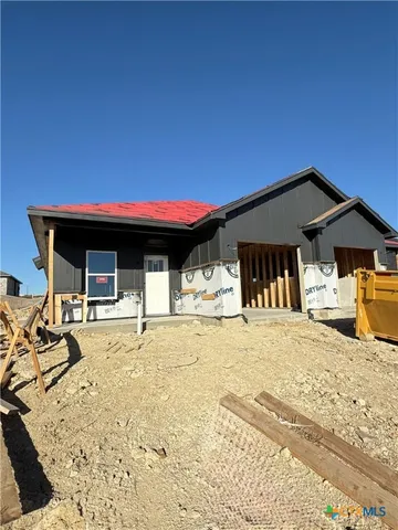 a view of a house with snow on the road