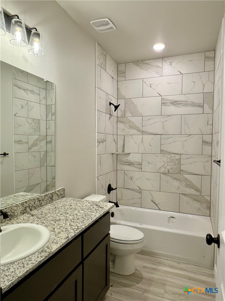 110 Leon Lane Copperas Cove, TX 76522 - Photo 11 of 20 a bathroom with a granite countertop sink toilet and shower