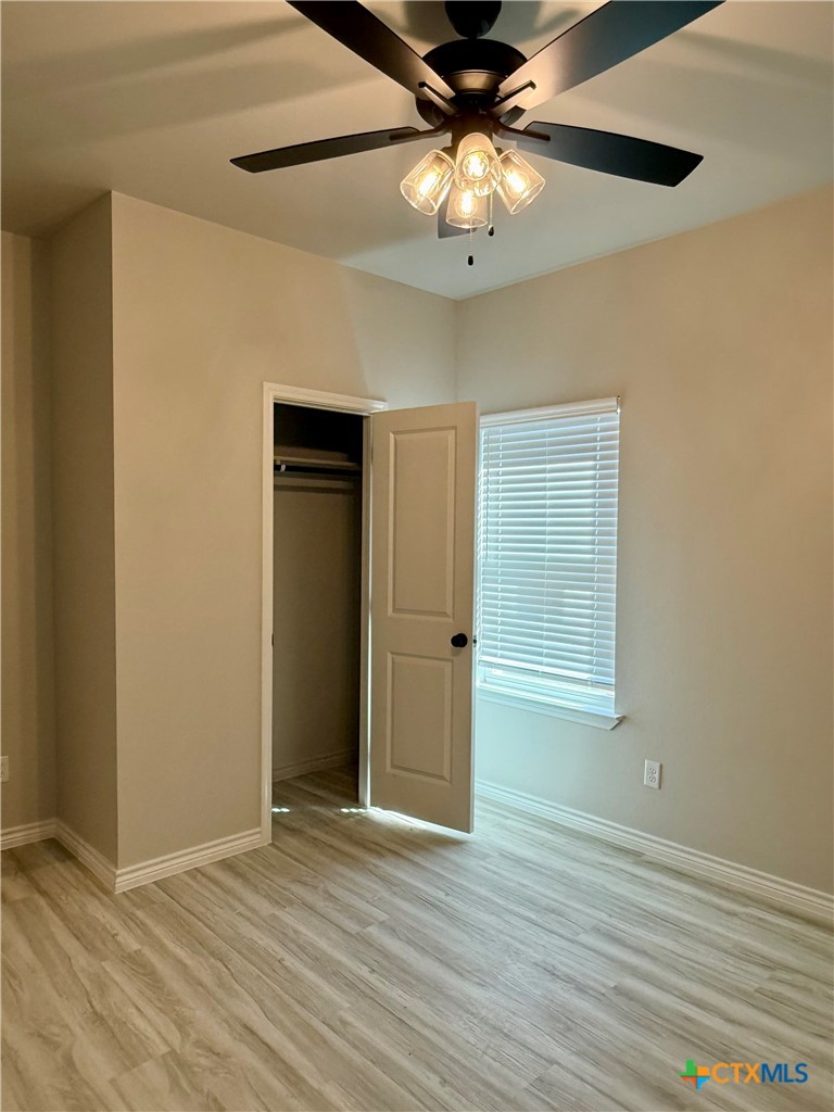 110 Leon Lane Copperas Cove, TX 76522 - Photo 13 of 20 an empty room with wooden floor closet and windows